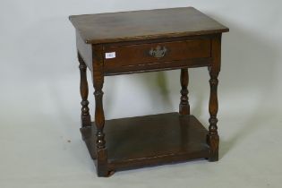 Antique style oak two tier single drawer side table, raised on baluster shaped supports, 48 x 60 x