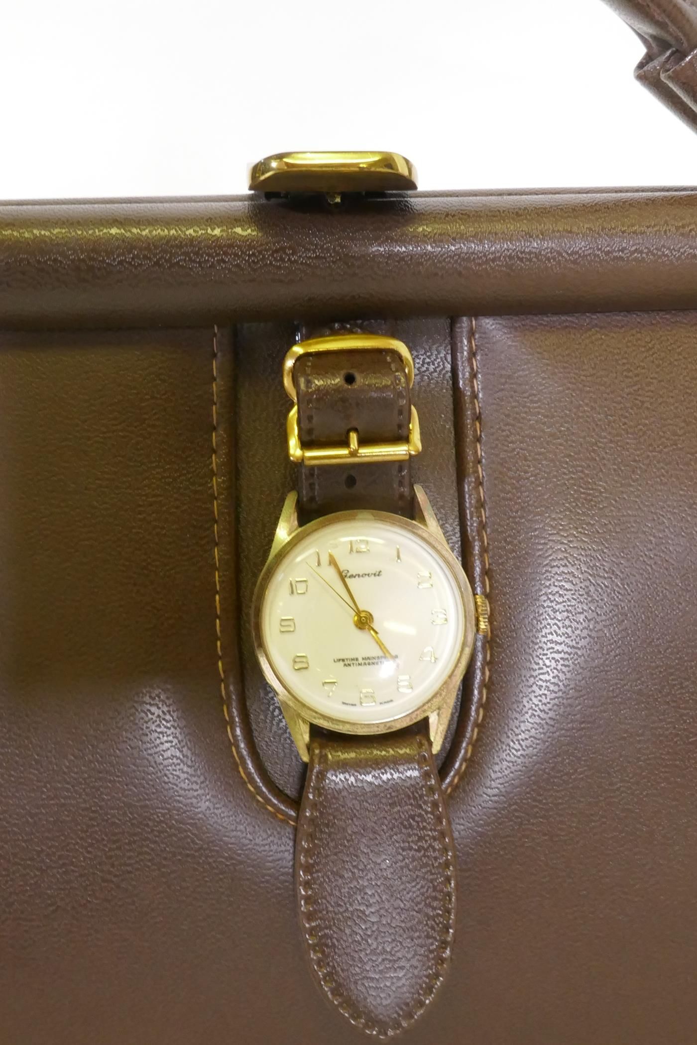 A vintage leather handbag with Genovit watch clasp and brass mounts, 27 x 20cm - Image 2 of 2