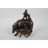 A Chinese filled bronze figure group of children playing on a buffalo, 18cm high