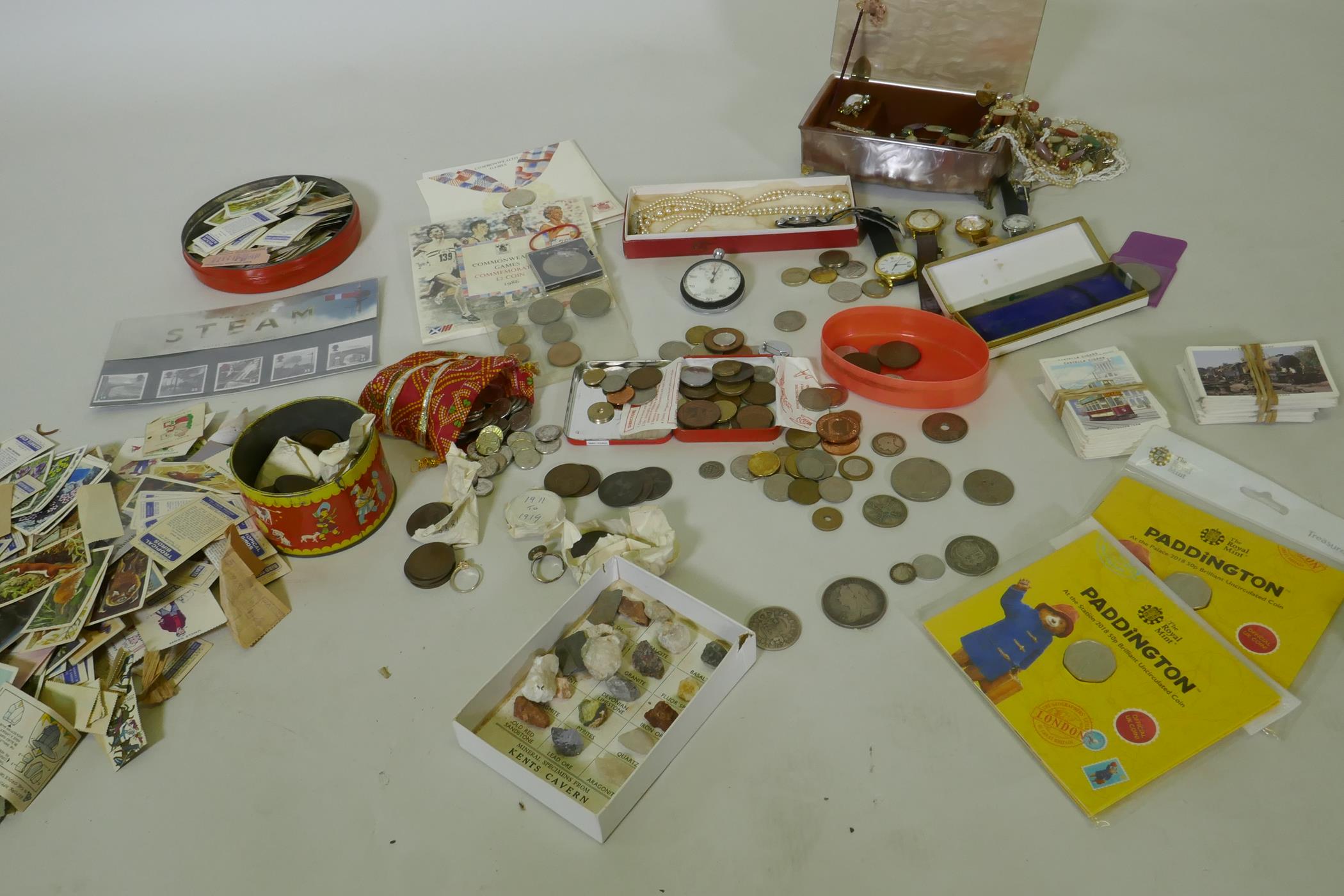 A quantity of UK and world coins, costume jewellery, stamps, cigarette cards, watches, Omega stop