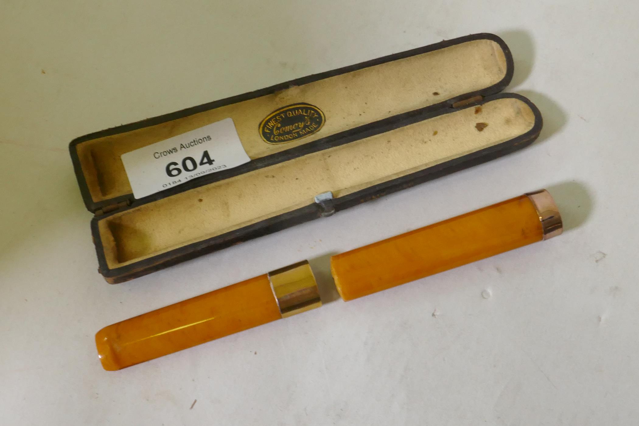 A Victorian amber cigar holder with 9ct gold mounts, cased with label Comoys London, 14cm long, AF - Image 3 of 3