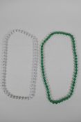 An apple green jade beaded necklace, together with a similar white jade beaded necklace, 70cm long