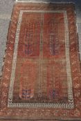 An antique Turkish rust ground wool rug, 90 x 160cm