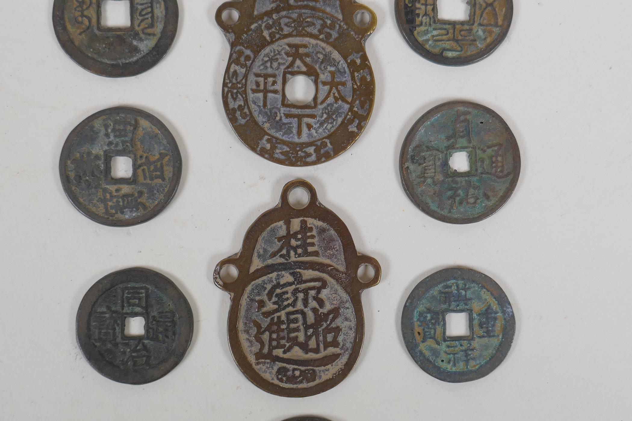 Eight Chinese facsimile (replica) bronze coins, and a pair of Chinese bronze medallions, 4 x 6cm - Image 3 of 4
