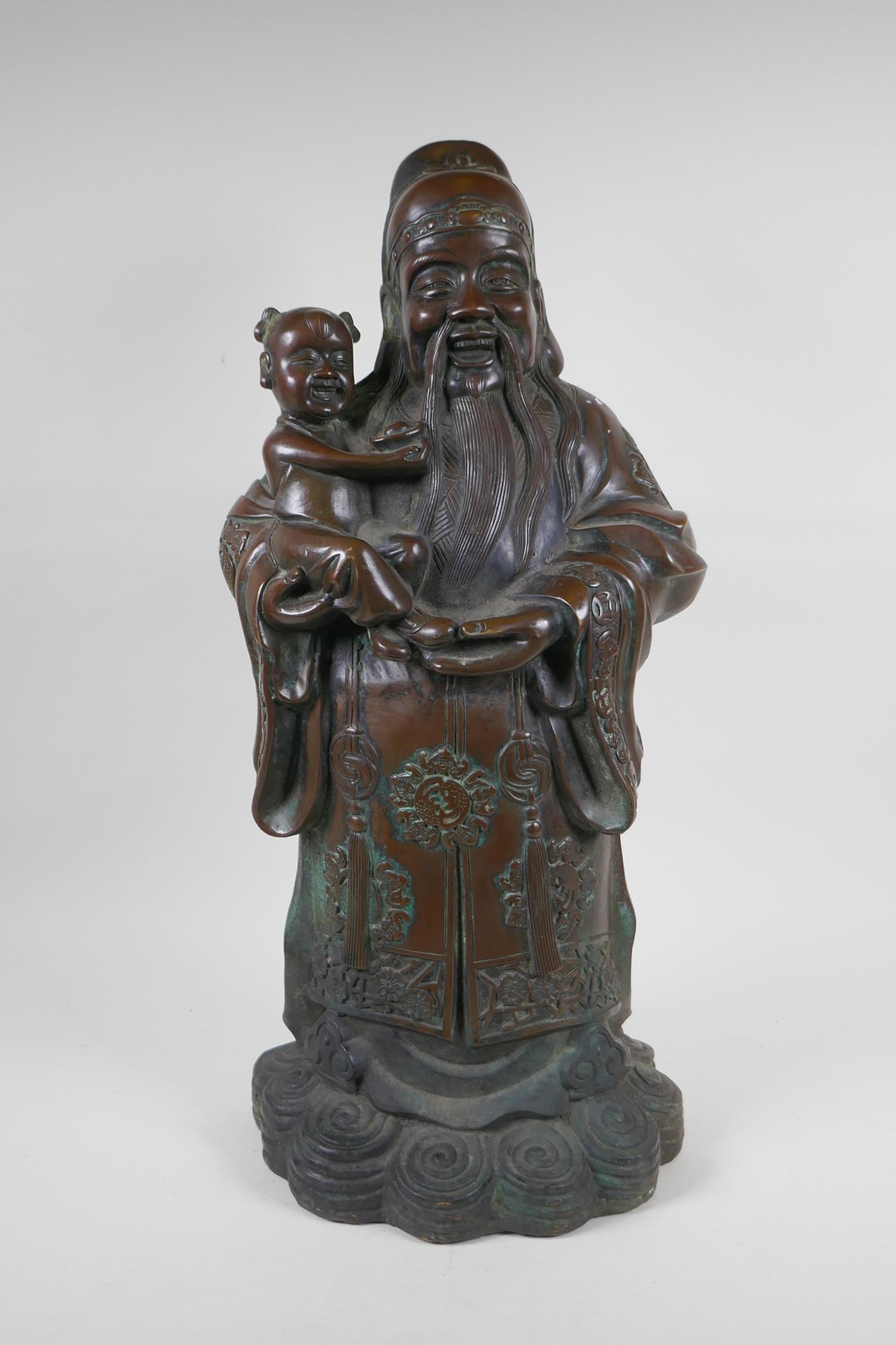 A Chinese filled bronze figure of Fu, character mark to base, 55cm high
