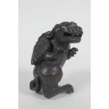 A Chinese bronze figure of a winged mythical beast, 10cm high