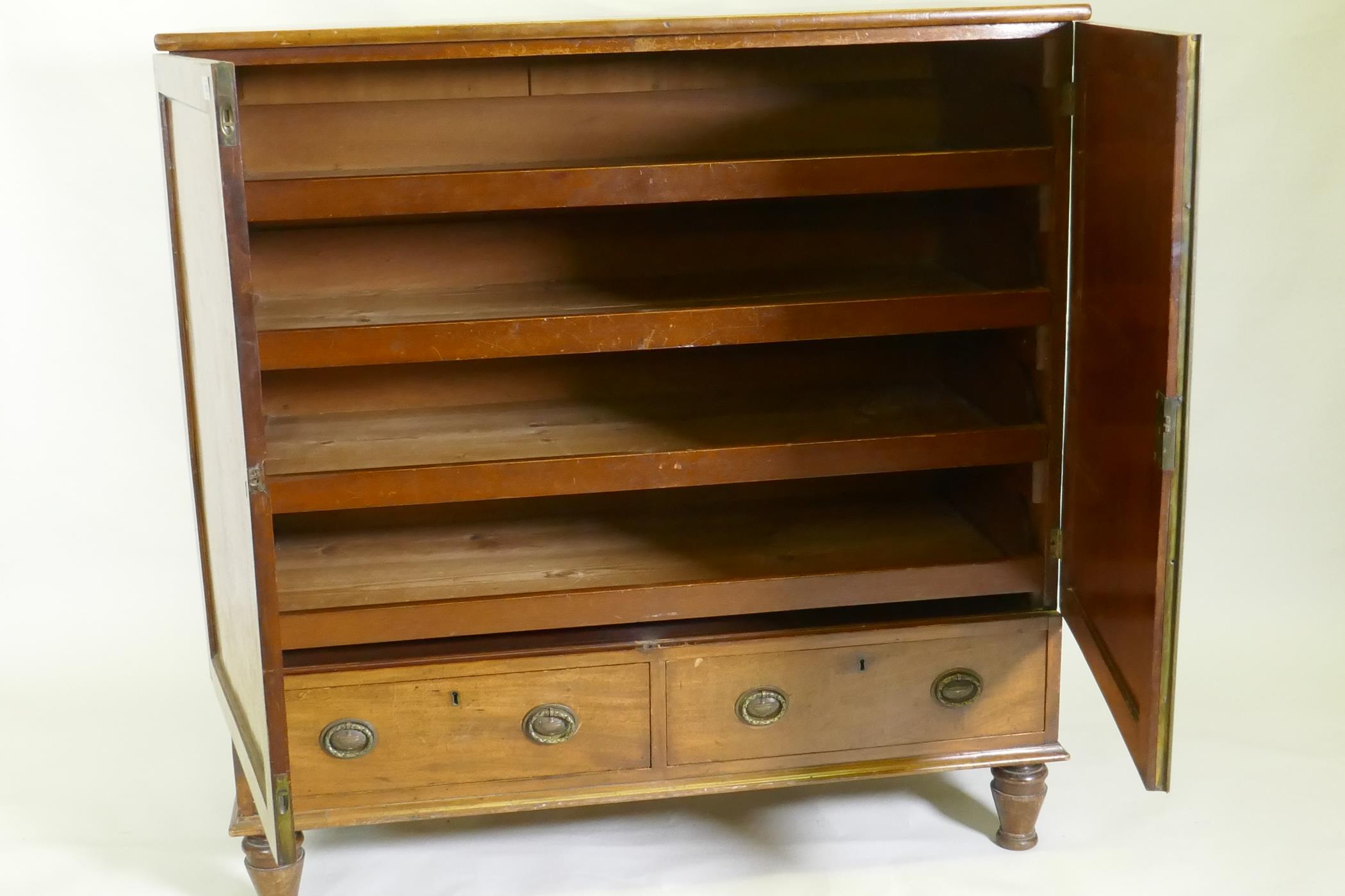 A Regency mahogany press cupboard, with two doors opening to reveal slide drawers over a single - Image 3 of 3