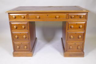 A Victorian mahogany nine drawer pedestal desk, with moulded feet details, wood knobs and inset