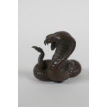 A Japanese style bronze okimono cobra, seal mark to base, 4cm high