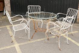 A vintage French wrought iron garden/bistro table and four chairs, early/mid C20th, table 87cm