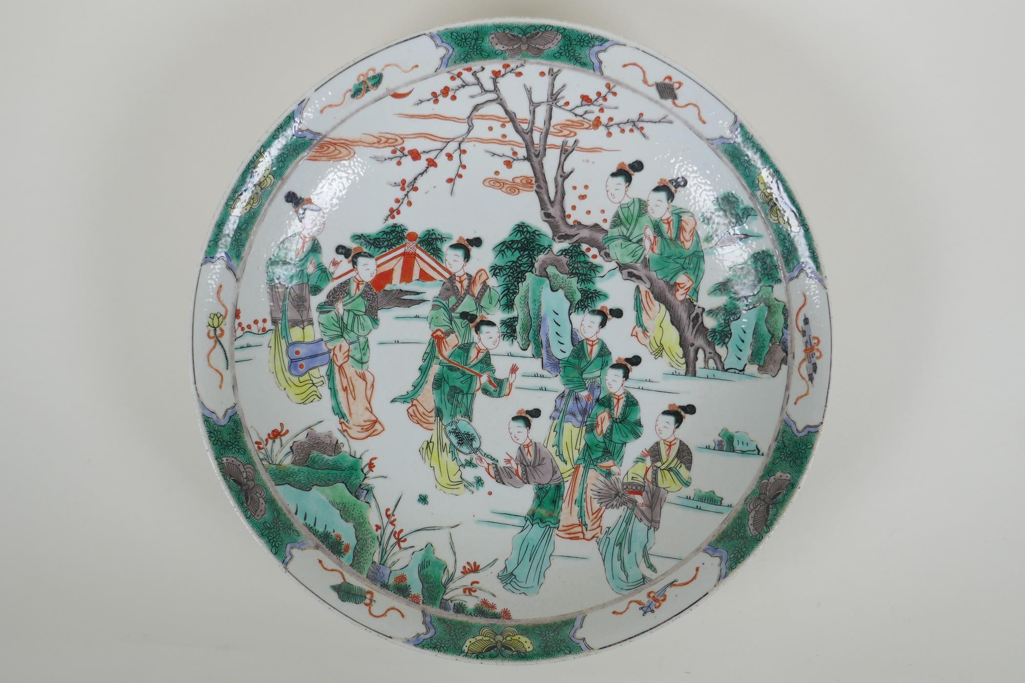 A Chinese KangXi style famille verte porcelain charger decorated with women in a landscape, vase