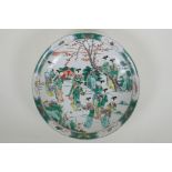 A Chinese KangXi style famille verte porcelain charger decorated with women in a landscape, vase