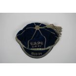 A pre WWII Rugby Union blue velvet cap for the 1933-34 season, with silver embroidered club initials