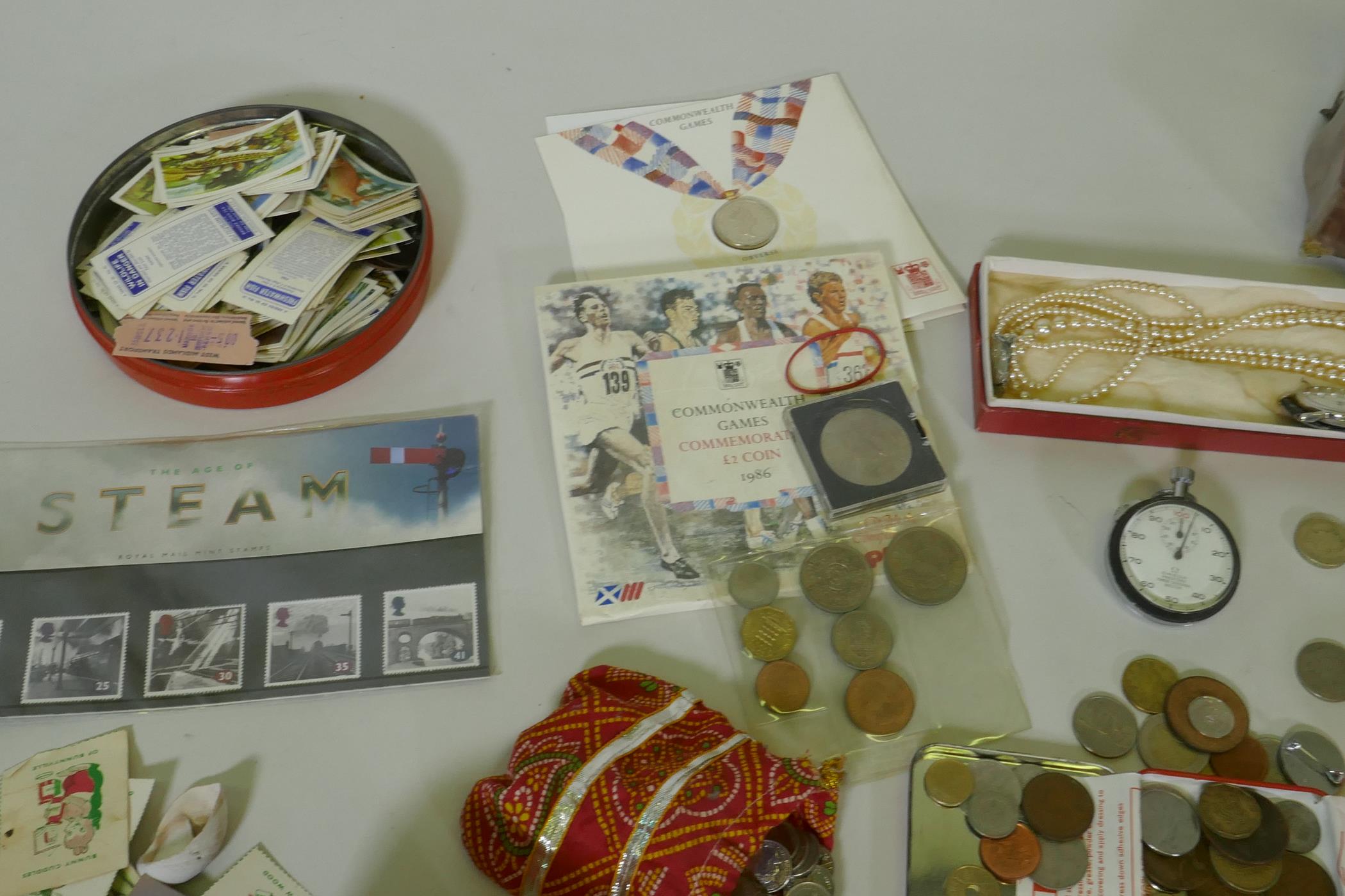 A quantity of UK and world coins, costume jewellery, stamps, cigarette cards, watches, Omega stop - Image 5 of 6