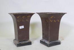 A pair of painted toleware vases raised on paw feet, 29cm high