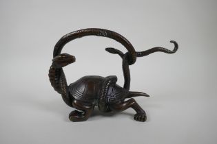 A Chinese filled bronzed metal tortoise entwined with a snake, 26cm long, 17cm high