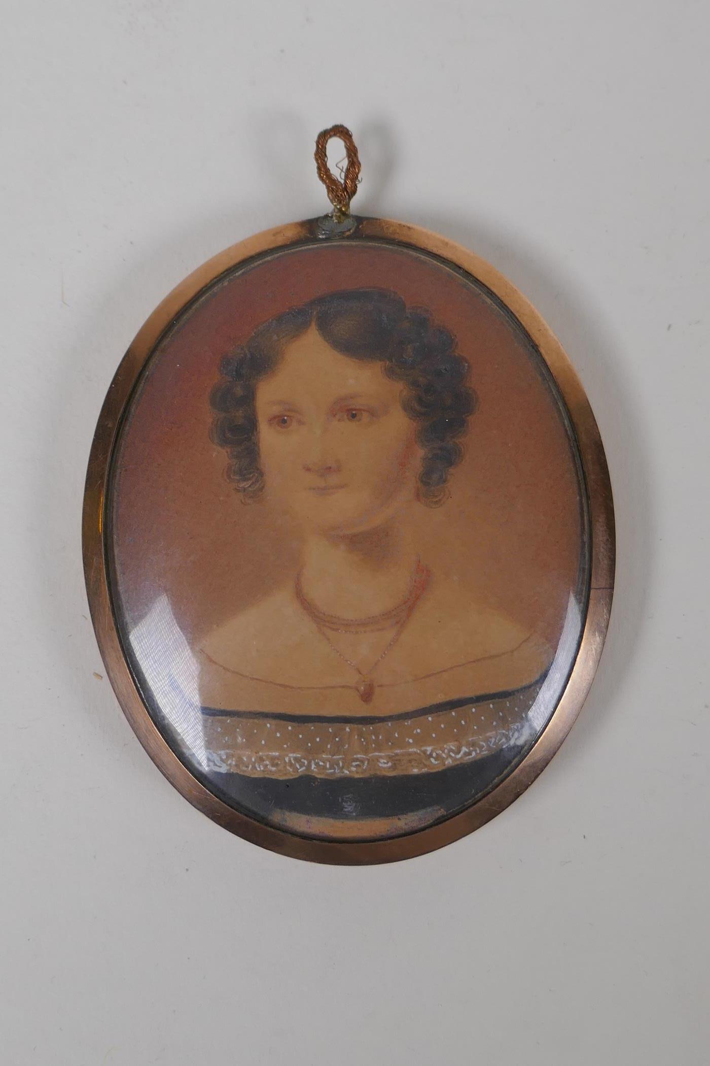 An early C19th miniature watercolour portrait of a lady in a rose metal pendant frame, with - Image 2 of 7