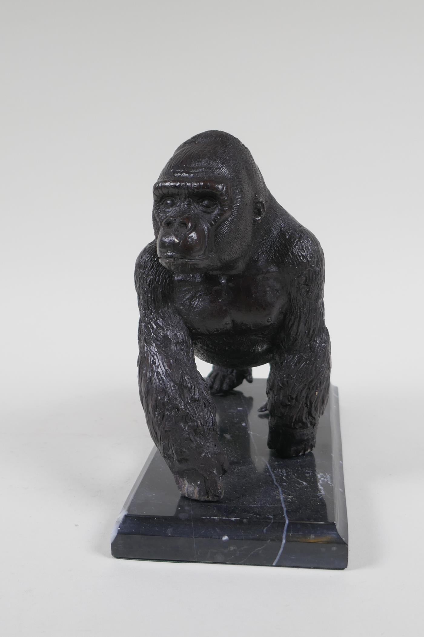 A cast bronzed metal gorilla, mounted on a marble base, 18cm high - Image 2 of 3