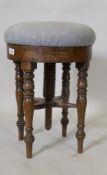 An early C19th mahogany revolving piano stool, 50cm high