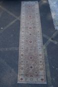 A cream ground wool Ziegler Mahal runner decorated with floral medallions, 85 x 350cm