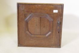 A late C17th/early C18th oak spice cupboard with moulded panel door, 43 x 22 x 4cm