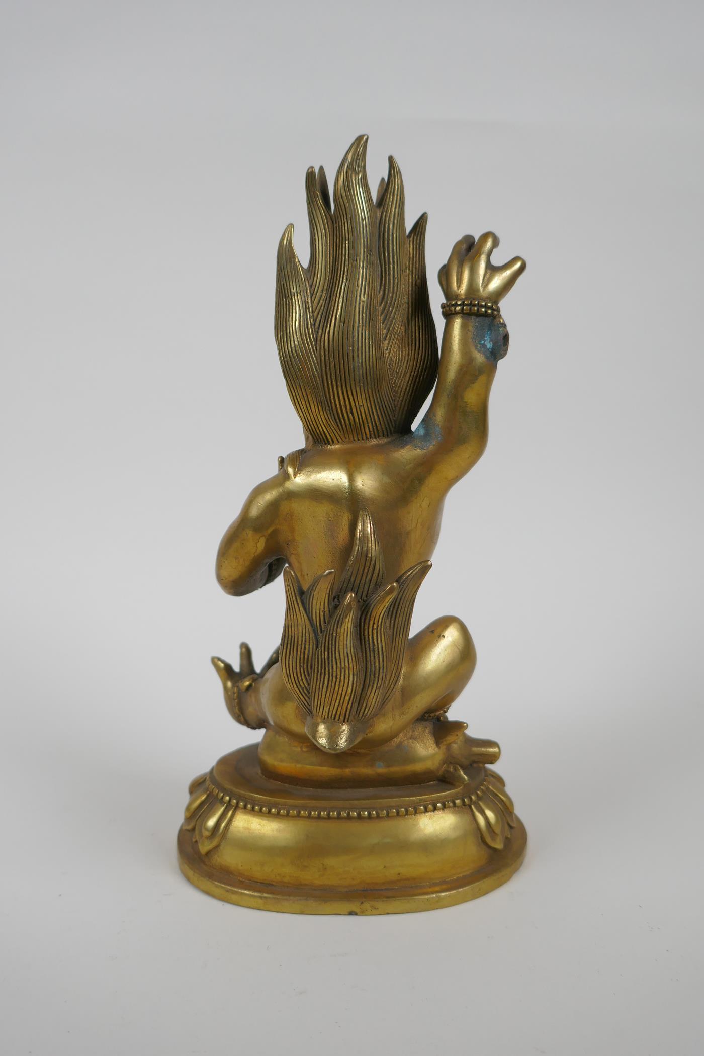 A Tibetan bronze of a wrathful beast seated on a pig, double vajra mark to base, 22cm high - Image 4 of 5