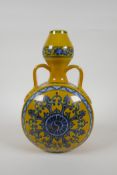 A Chinese yellow ground porcelain moon flask with garlic head shaped neck, two handles and blue