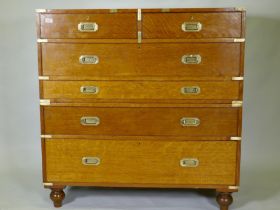 A fine late C19th/early C20th golden oak secretaire campaign style chest of two sections, the