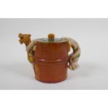 A Chinese sancai crackle glazed pottery teapot with kylin handle and spout, 11cm high