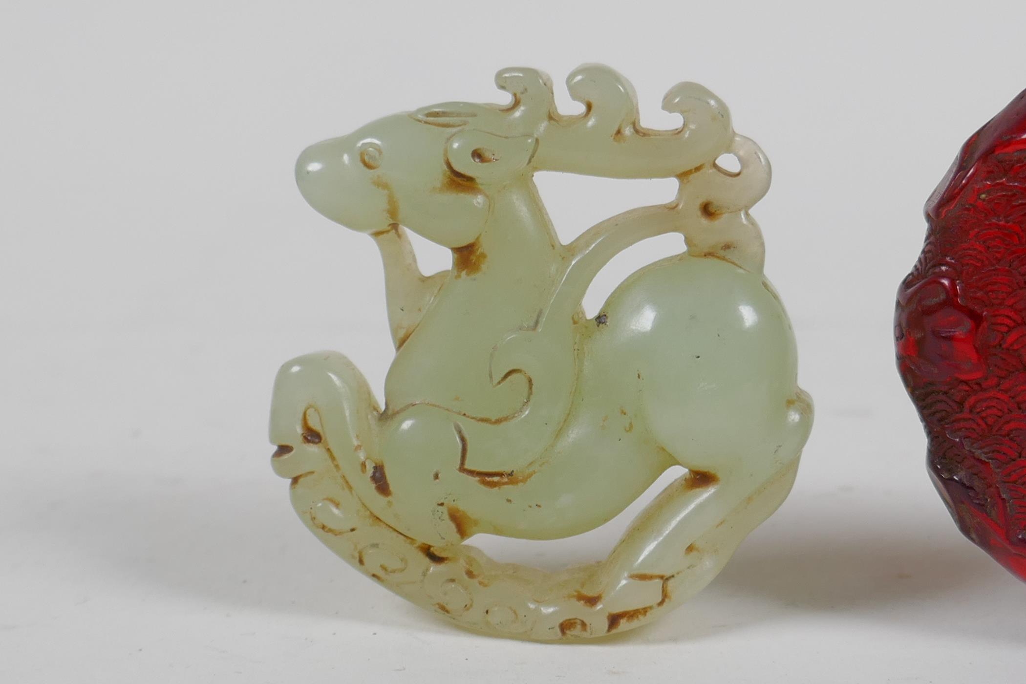 A Chinese carved hardstone roundel in the form of a deer, and a faux amber snuff bottle, 7cm high - Image 2 of 4