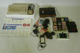 A Commodore 64 personal computer and Atari video game console with joysticks and games