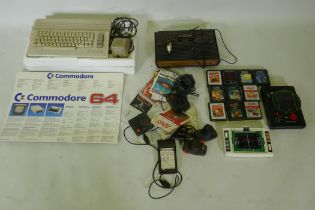 A Commodore 64 personal computer and Atari video game console with joysticks and games