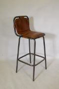 A Charlotte Perriand style tubular metal and chestnut leather bar stool, 106cm high