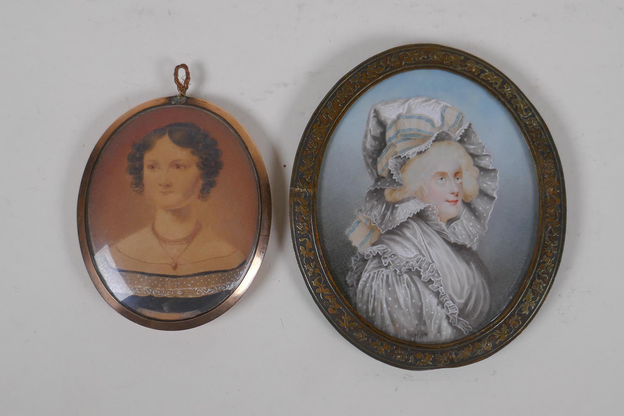 An early C19th miniature watercolour portrait of a lady in a rose metal pendant frame, with