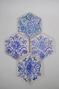 Four Iznik hexagonal pottery tiles decorated with blue and white foliate designs, 14 x 17cm