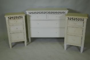 A painted bedroom suite, two three drawer bedside cupboards, 17cm high, and a chest of drawers, 90 x