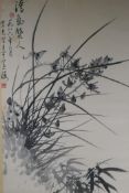 A Chinese monochrome watercolour of orchids and bamboo, signed, early C20th, 44 x 67cm