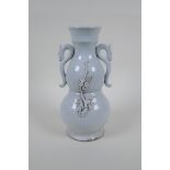 A blanc de chine porcelain two handled double gourd vase with raised prunus blossom decoration,