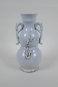 A blanc de chine porcelain two handled double gourd vase with raised prunus blossom decoration,