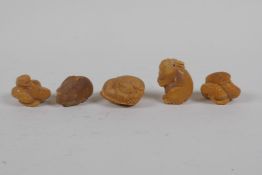 Five Japanese carved tagua nut netsuke in the form of rabbits, snakes and rats, 4cm