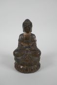 A Chinese filled gilt bronze figure of Buddha, 4 character mark to base, 14cm high