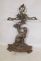 A Victorian style cast iron stick stand in the form of a seated dog with the legend Cave Canem, 75cm