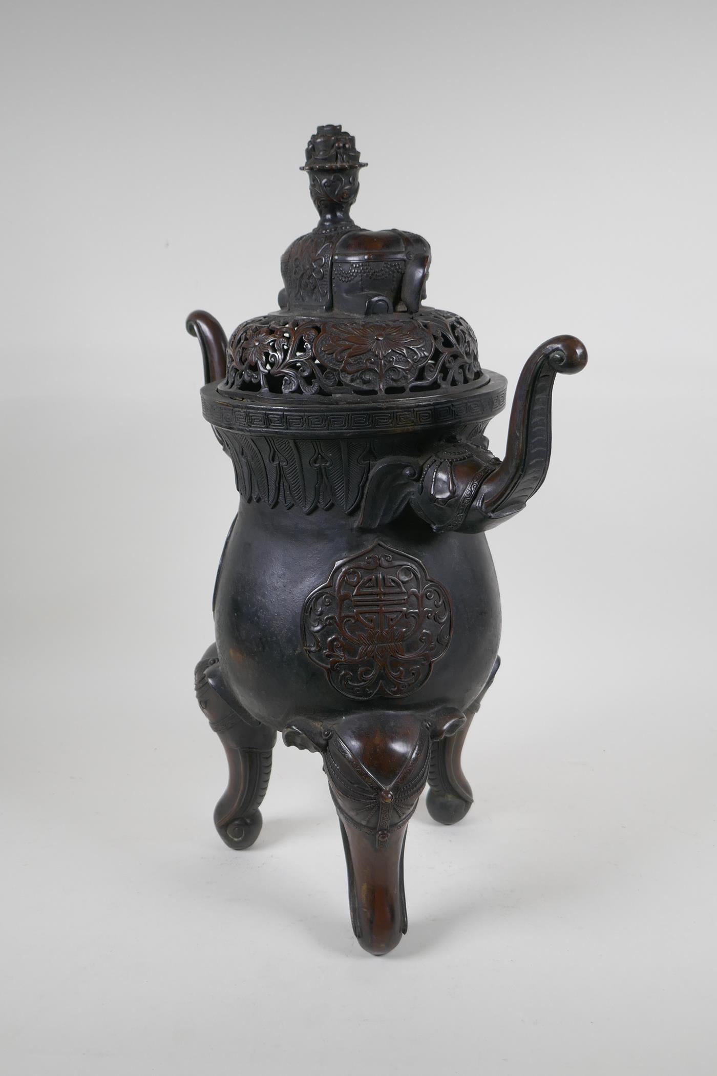 A Chinese bronzed metal two handled censer and pierced cover, raised on elephant head tripod - Image 6 of 8