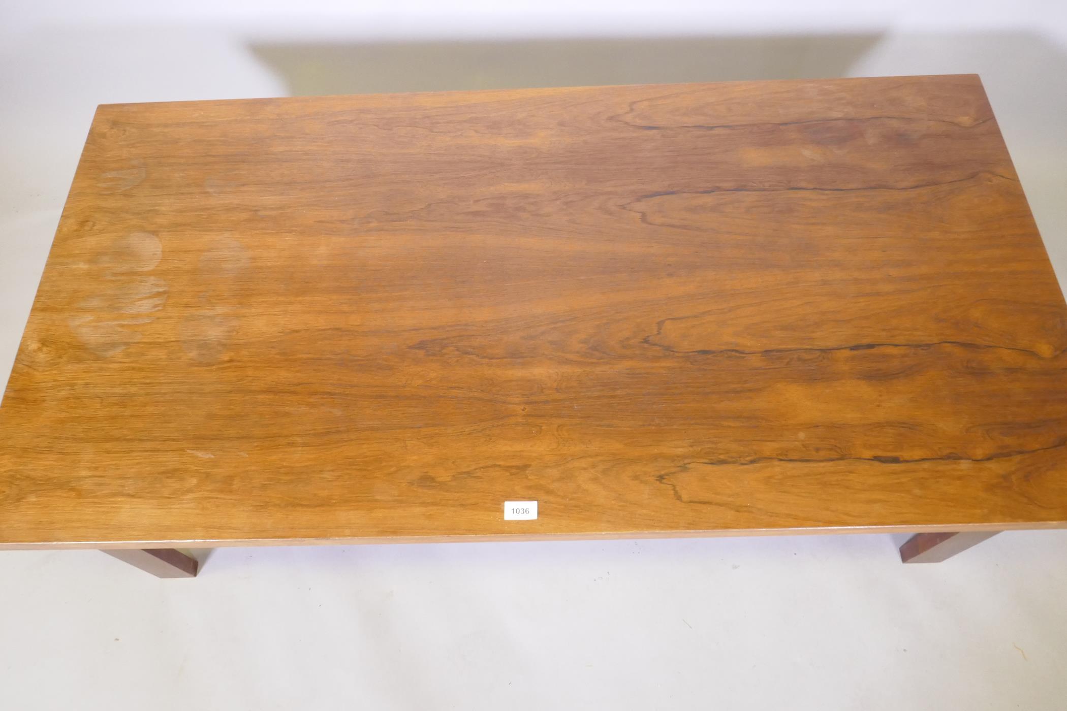 A mid century rosewood coffee table raised on square supports, 70 x 138 x 45cm - Image 4 of 4