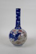 A Chinese crackleware bottle vase with blue, white and red decoration of a dragon and phoenix in