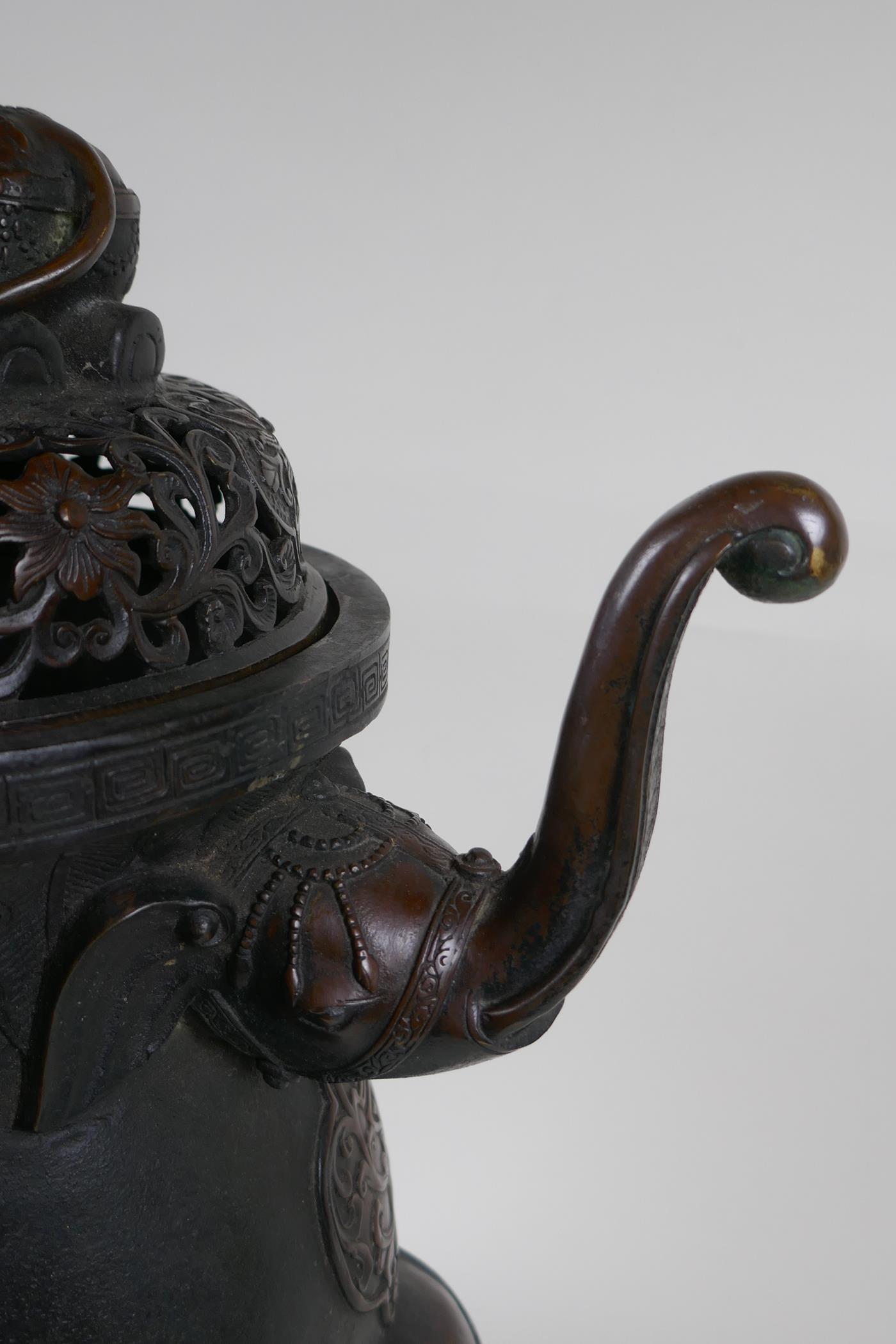 A Chinese bronzed metal two handled censer and pierced cover, raised on elephant head tripod - Image 4 of 8