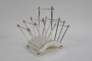 A Christopher Dresser style silver plated letter rack, 18cm high x 21cm long