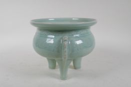 An oriental celadon glazed porcelain censer with tripod supports and archaic underglaze