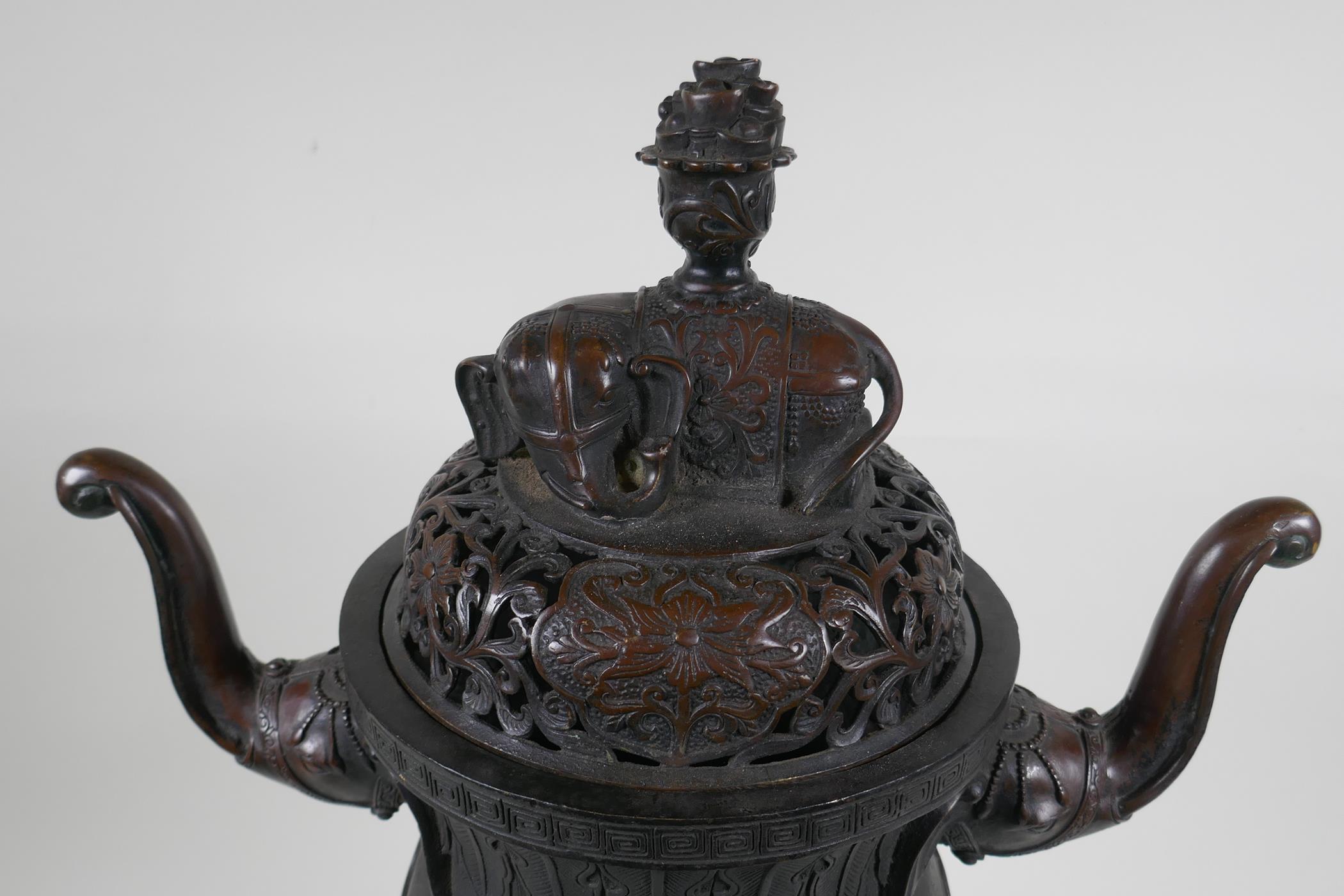 A Chinese bronzed metal two handled censer and pierced cover, raised on elephant head tripod - Image 3 of 8