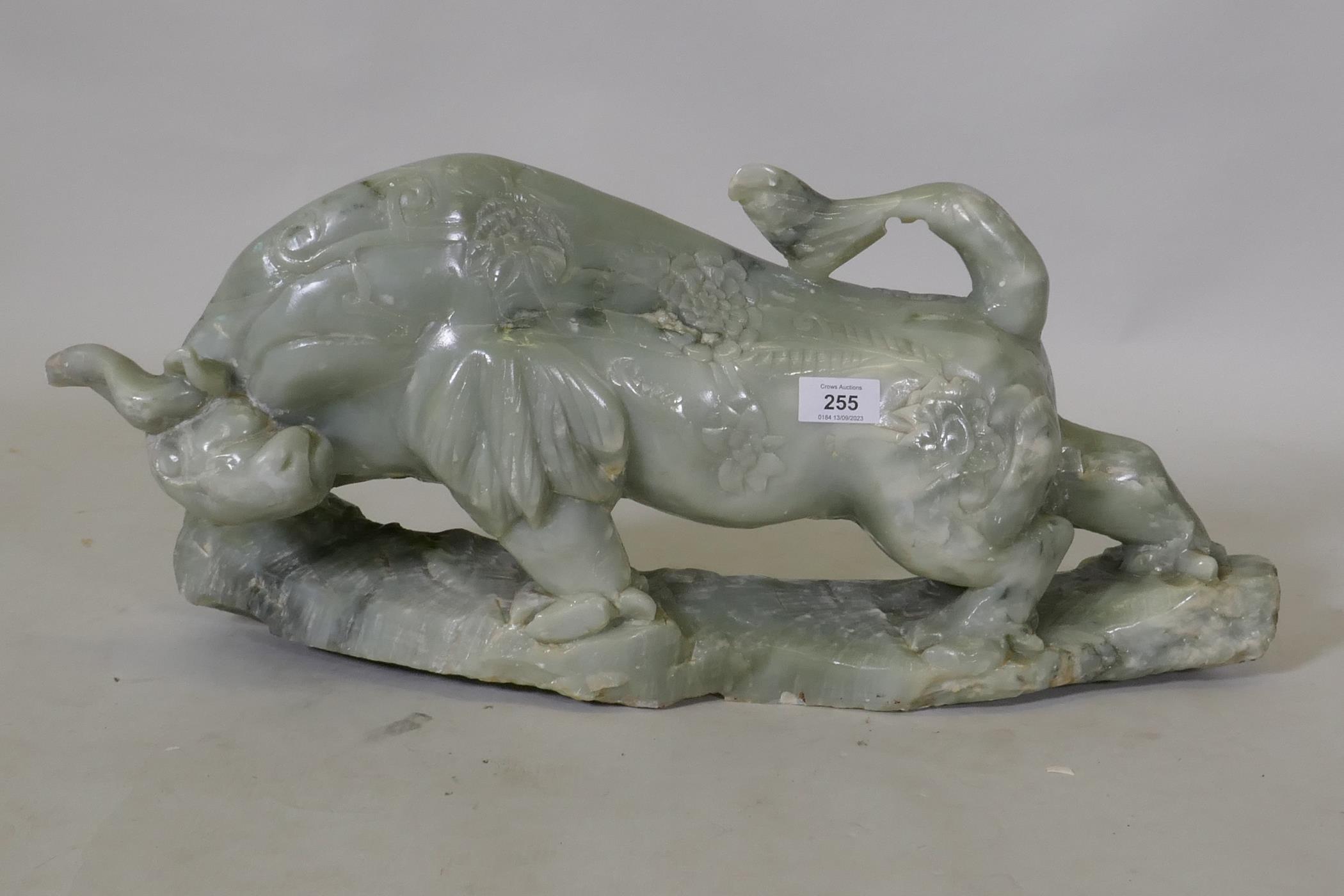 A Chinese carved soapstone figure of a bull, 58 x 28cm